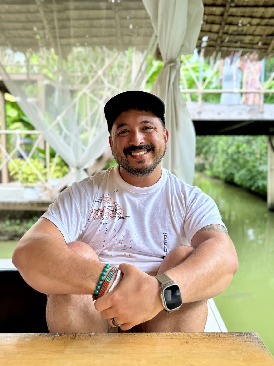 Tim Testa seated beside a canal in Thailand
